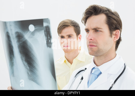 Concentrated doctor and patient examining lungs x-ray Stock Photo