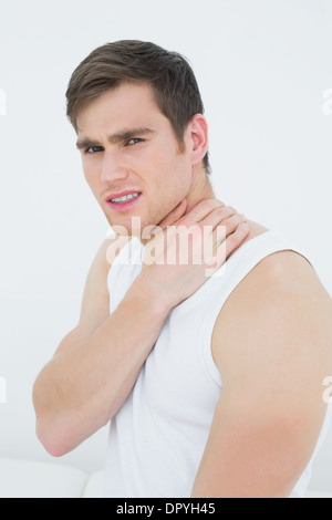 Side view portrait of a young man suffering from neck pain Stock Photo