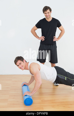 Portrait of physical therapist with young man doing push ups Stock Photo