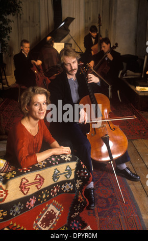 Alan Rickman British actor playing cello Juliet Stevenson British actress on film set of Truly Madly Deeply.  London, England  March 1990 1990s HOMER SYKES Stock Photo