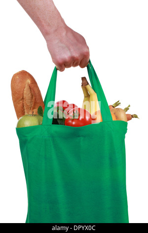 Hand holding a bag filled with groceries, isolated on white Stock Photo