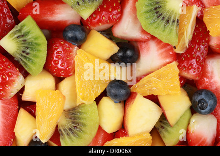 Top view of a fruit salad with strawberries, oranges, kiwi, blueberries and peaches Stock Photo
