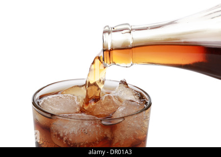 Cola is pouring from a bottle into a glass Stock Photo