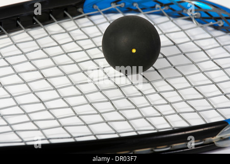 squash ball on a racket Stock Photo