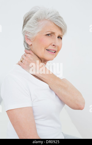Side view portrait of a senior woman suffering from neck pain Stock Photo