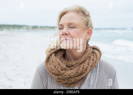 Close-up of a contemplative senior woman at beach Stock Photo