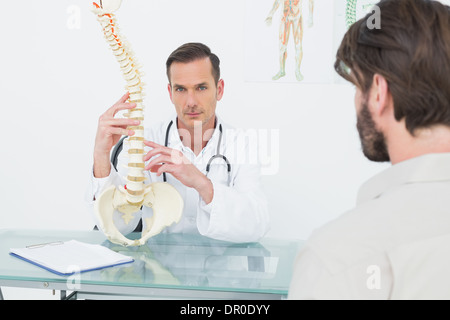 Portrait of a doctor explaining the spine to a patient Stock Photo