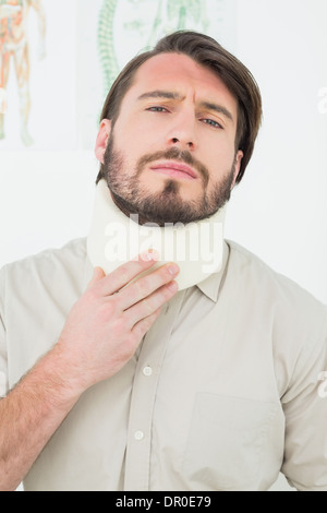 Portrait of a young man suffering from neck pain Stock Photo