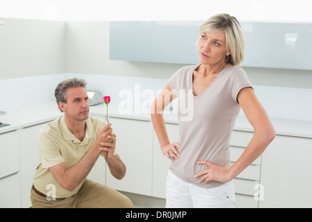 Man making a proposal to woman in kitchen Stock Photo
