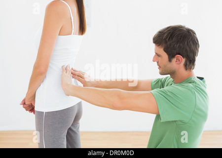 Physiotherapist examining woman's back in medical office Stock Photo
