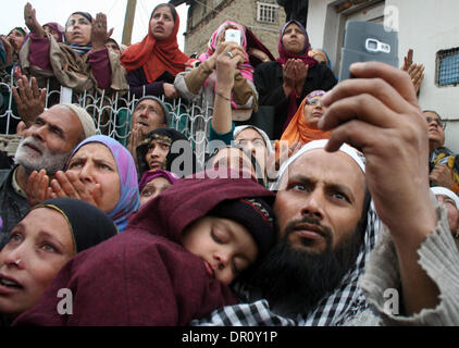 Srinagar, Indian Administered Kashmir17 January. Kashmiri Muslim devotees raise hands as they look towards the relic displayed by a cleric (not in picture) believed to be whisker from the beard of Prophet Muhammad at the Hazratbal shrine in Srinagar, the summer capital city of Indian-administered Kashmir. Thousands of devotees from across Kashmir converged at the Hazratbal shrine to pay obeisance on the occasion of Friday following Eid-Milad-Un-Nabi (the birth anniversary of Prophet Muhammad)  (Sofi Suhail/ Alamy Live News) Stock Photo