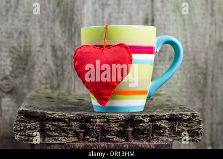 Heart hung on a colored cup Stock Photo