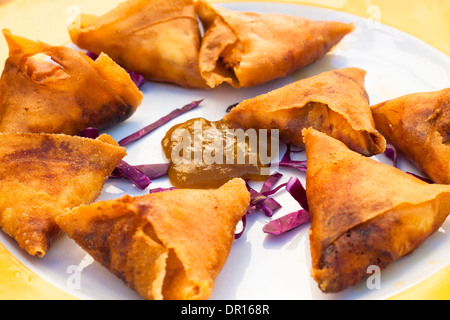 Spanish Tapas plate with golden fried filled pastry triangles and sauce. Stock Photo