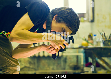 Caucasian photographer working in studio Stock Photo