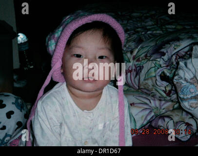 December 09, 2008. San Diego,  CA.     This is GRACE YOON, 15 months-old. Husband and father DONG YUN YOON visited the remains of his University City home, the day after a military F-18D crashed into the structure killing his wife, two young daughters and his mother-in-law. He tearfully addressed the media giving thanks to his church and those who have supported him in this terribl Stock Photo