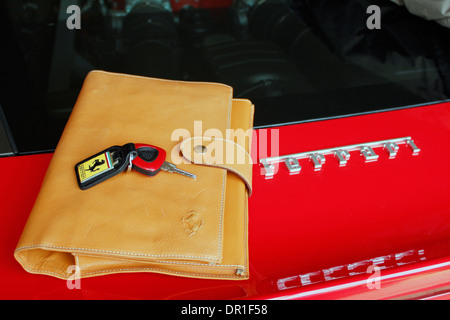 Ferrari hand made leather document folder and  car keys Stock Photo