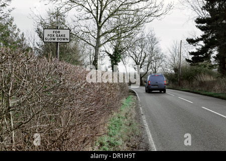 Humorous slow down road sign with breaking van Stock Photo