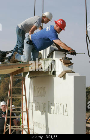 December 4, 2008, Oceanside, California, USA RICHARD ROBERTS, left, and SHANNON JARRETT, right, install anchor bolts into the top of this section of the Mission San Luis Rey's new concrete 12 foot tall sign. The bolts are to be used to attach cables to them so a crane can lift it up and place in on the sign's base Credit: photo by Charlie Neuman, San Diego Union-Tribune/Zuma Press. Stock Photo