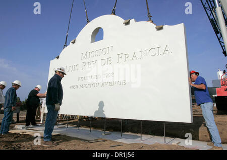 December 4, 2008, Oceanside, California, USA Workers guide a section of the Mission San Luis Rey's new 12 foot tall concrete sign into place on its base. Another section of the same size, but with writing facing the opposite direction, will be ''sandwiched'' to this one with pillars on either and a decorative ''cap'' placed on top. Looking at the sign is GEORGE SCHULTZ, of Quick Cr Stock Photo
