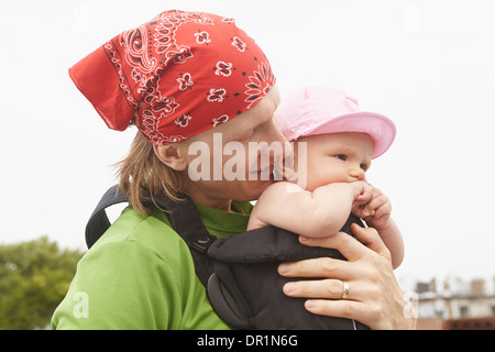 Father carrying baby outdoors Stock Photo