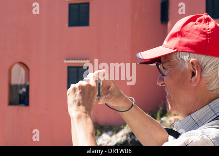 Senior man tourist taking photos using compact camera. Stock Photo