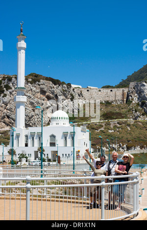 Group of happy tourists and Ibrahim-al-Ibrahim Mosque at Europa Point, Gibraltar, UK. Stock Photo