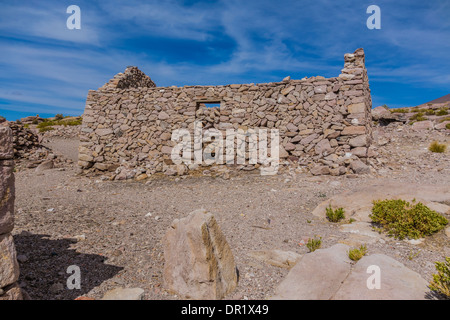 Abandoned rock houses missing roofs on Salar de Uyuni in southern Bolivia. Stock Photo