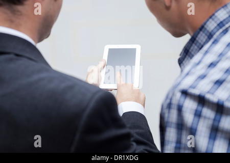 Detail of two businessmen using digital tablet. Stock Photo