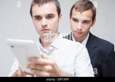 Closeup of two businessmen using digital tablet. Stock Photo