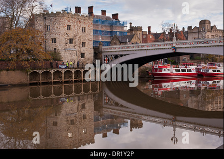 Lendal Bridge, historic stone tower on bank of River Ouse & moored city cruise boats reflected in water - scenic York, North Yorkshire, England, UK. Stock Photo
