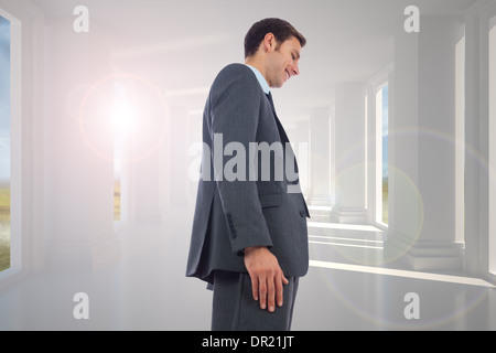 Composite image of cheerful handsome businessman standing Stock Photo