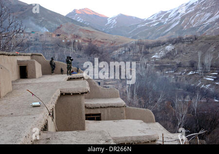 Afghan special operation force soldiers survey the valley for any suspicious activity during an operation to capture Taliban leaders January 15, 2014 in Ghorband district, Parwan province, Afghanistan. Stock Photo