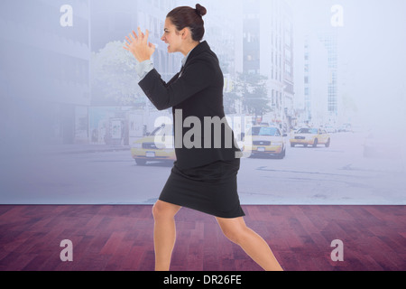 Composite image of angry businesswoman gesturing Stock Photo