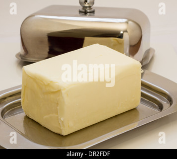 Butterdish stainless steel with butter isolated on white background. Stock Photo