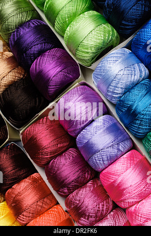 Different color threads on rows in the store Stock Photo