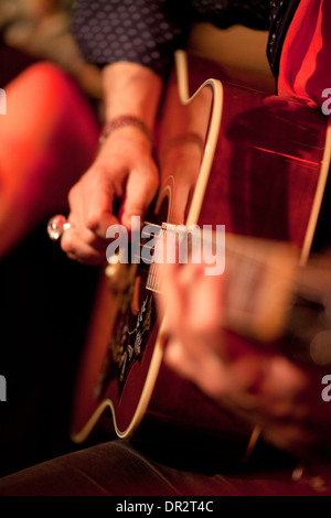 musician playing an acoustic guitar Stock Photo