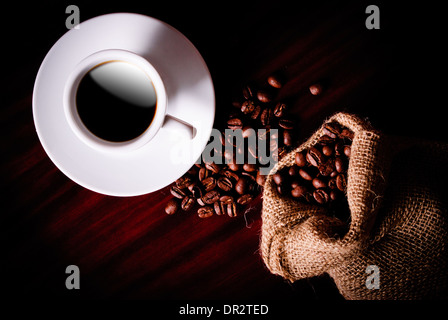 Coffee still life with cup, coffee beans in bag and sugar Stock Photo