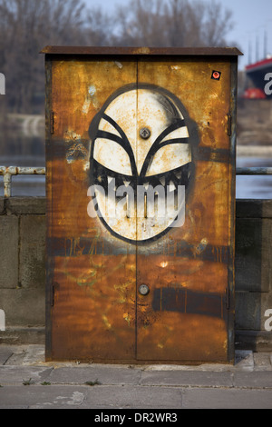 Scary alien face, graffiti on a metal surface in Warsaw, Poland. Stock Photo