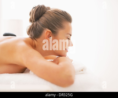 Young woman receiving hot stone massage Stock Photo