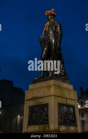 The statue of Robert Burns Scottish poet in George Square Glasgow dressed for the annual Burns Night celebration in January Stock Photo