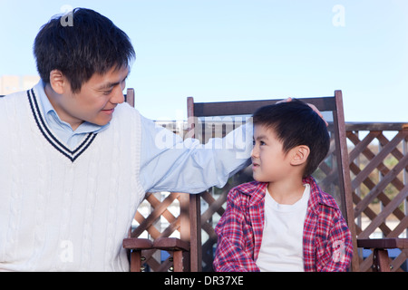 Father patting son on head Stock Photo - Alamy