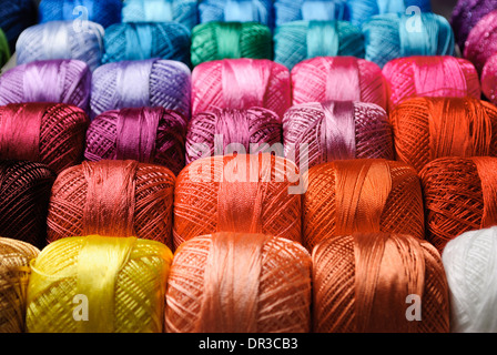Different color threads on rows in the store Stock Photo