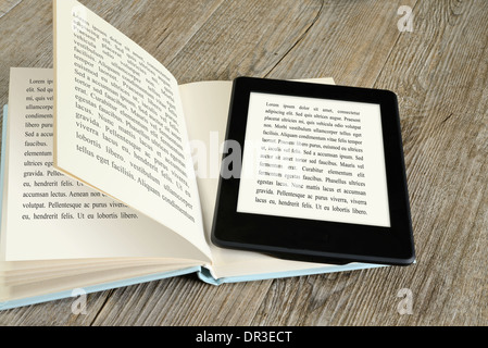 modern ebook reader on book on wooden table Stock Photo