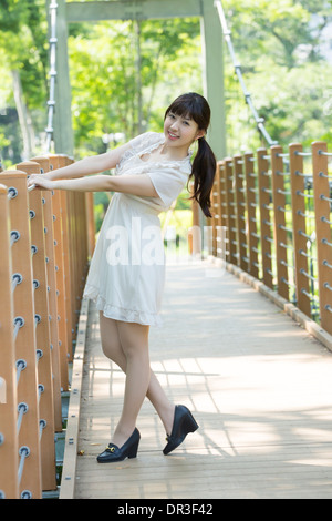 Young woman standing on bridge Stock Photo