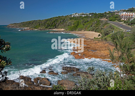 Coastal landscape with rocky bay, sandy beach and waterfront houses at Coolum Beach, Sunshine Coast Queensland Stock Photo