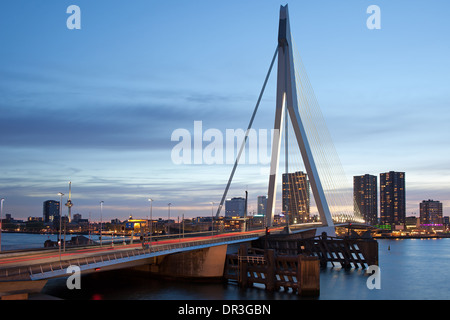 Erasmus Bridge (Dutch: Erasmusbrug) in the city centre of Rotterdam at dusk, South Holland, the Netherlands. Stock Photo
