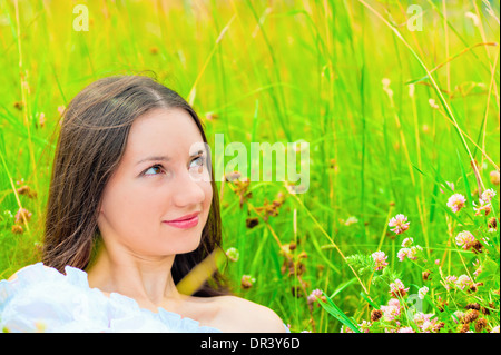 portrait of a girl in green grass and clover Stock Photo