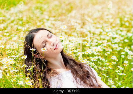 woman with closed eyes relaxes in daisies Stock Photo - Alamy