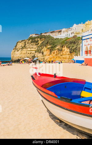 traditionally painted fishing boat on the beach of carvoeiro, algarve, portugal Stock Photo