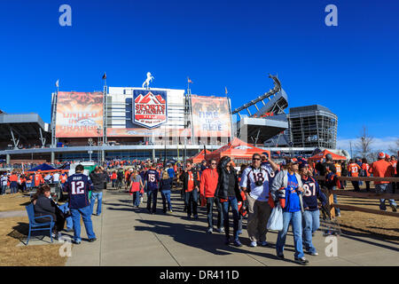 Denver Broncos fans enjoy some food and drinks with the city in the  background in the tailgate …